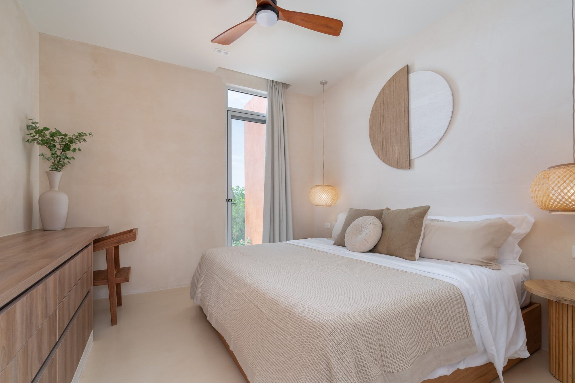Bedroom with a king bed, ceiling fan and wood dresser
