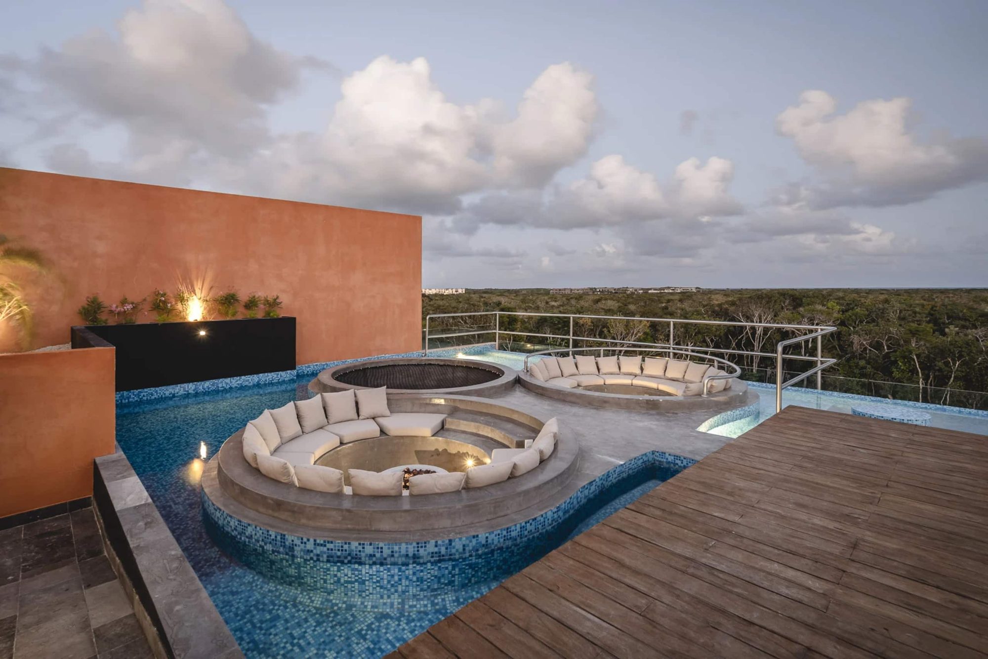 Rooftop sunken lounge and pool under evening light