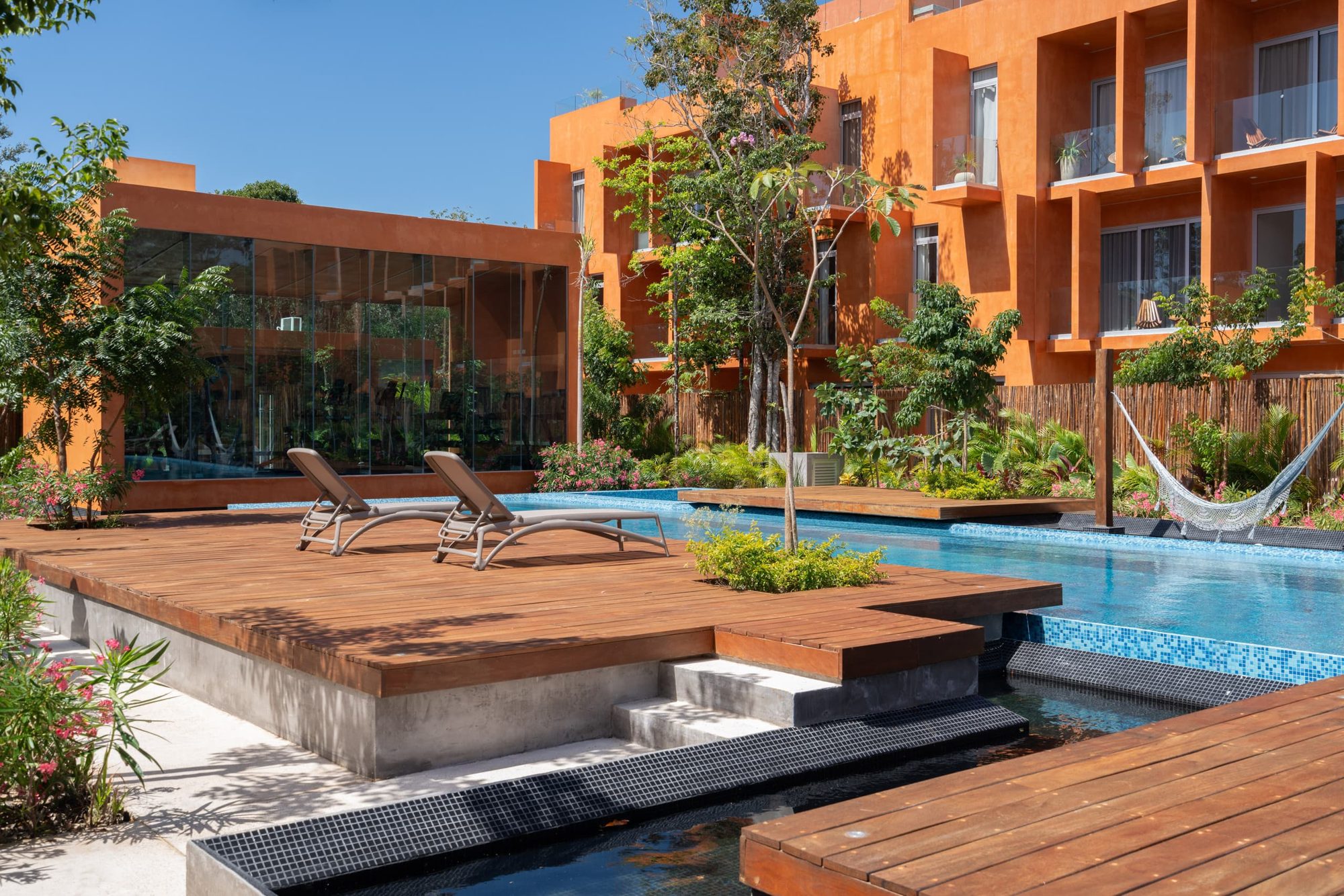 Pool decks and loungers among tropical plants