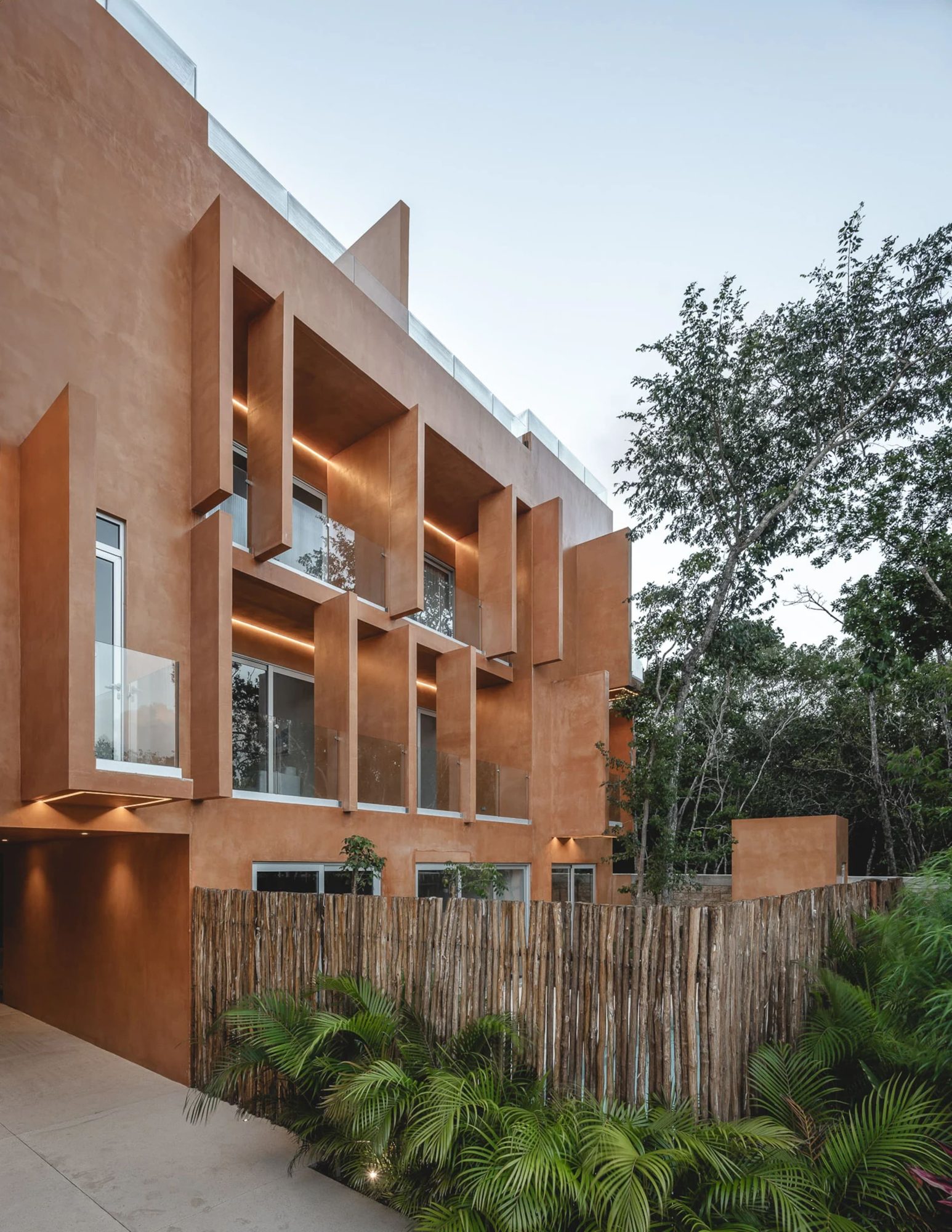 Building exterior with balconies and tropical plants