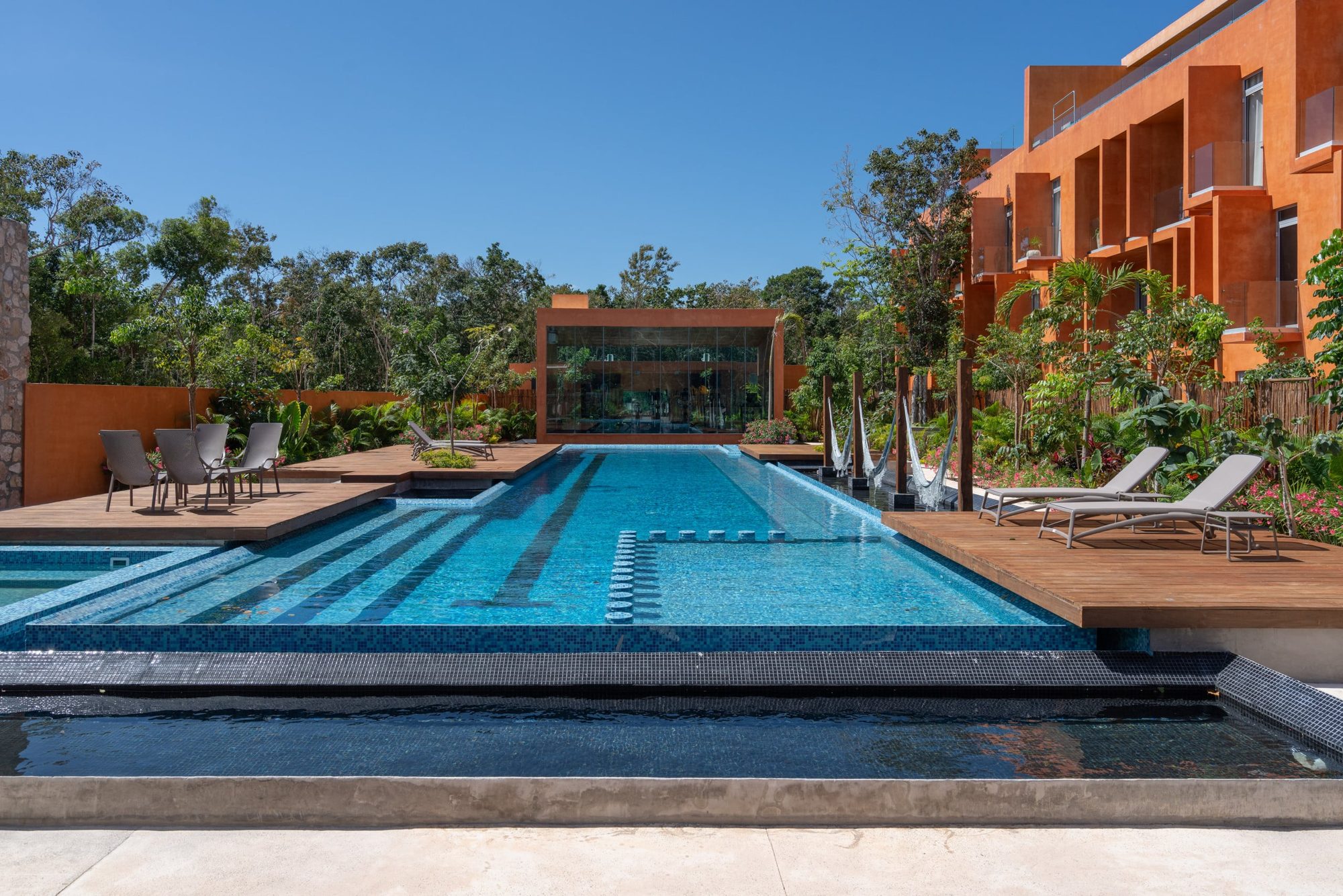 Community pool with wooden decks and loungers
