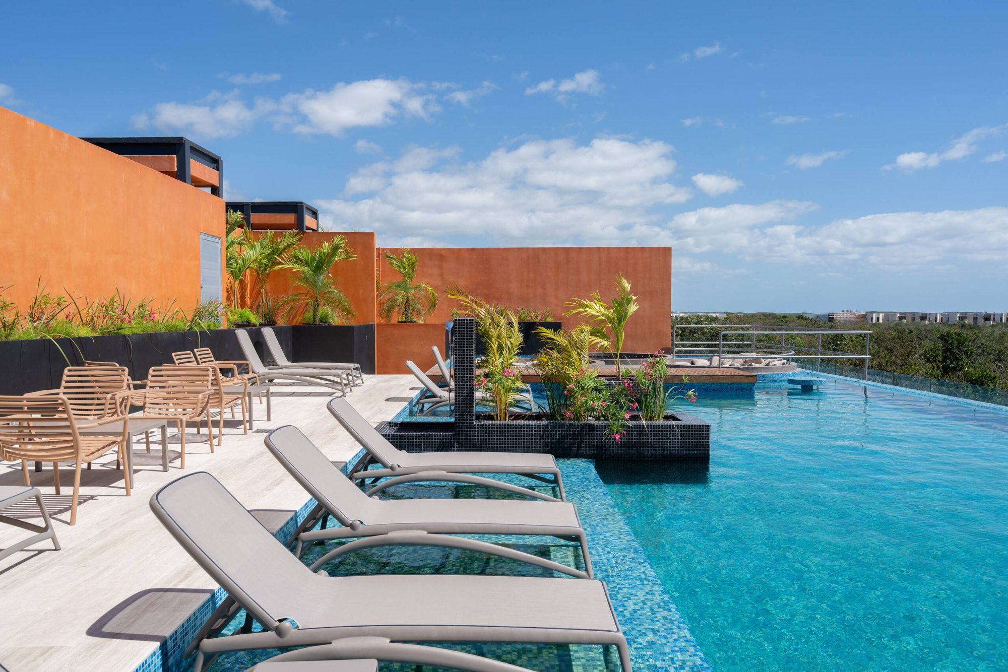 Rooftop loungers and tables beside the pool