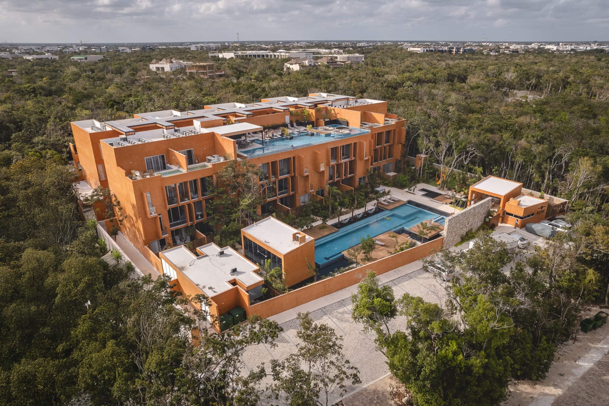 Aerial view of the community buildings and pools surrounded by jungle