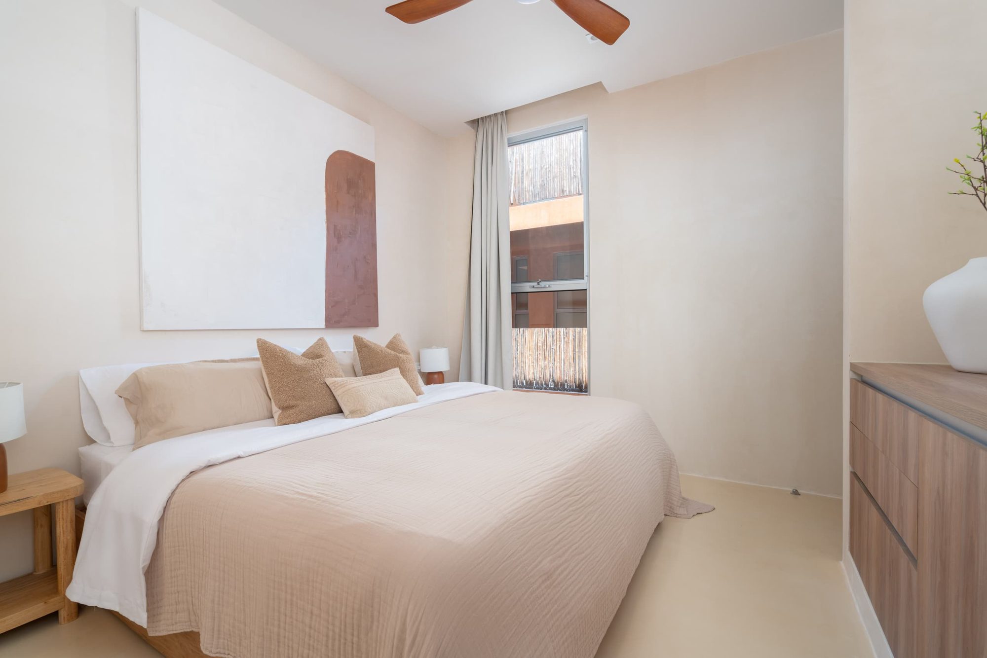 Bedroom with a king bed, ceiling fan and window