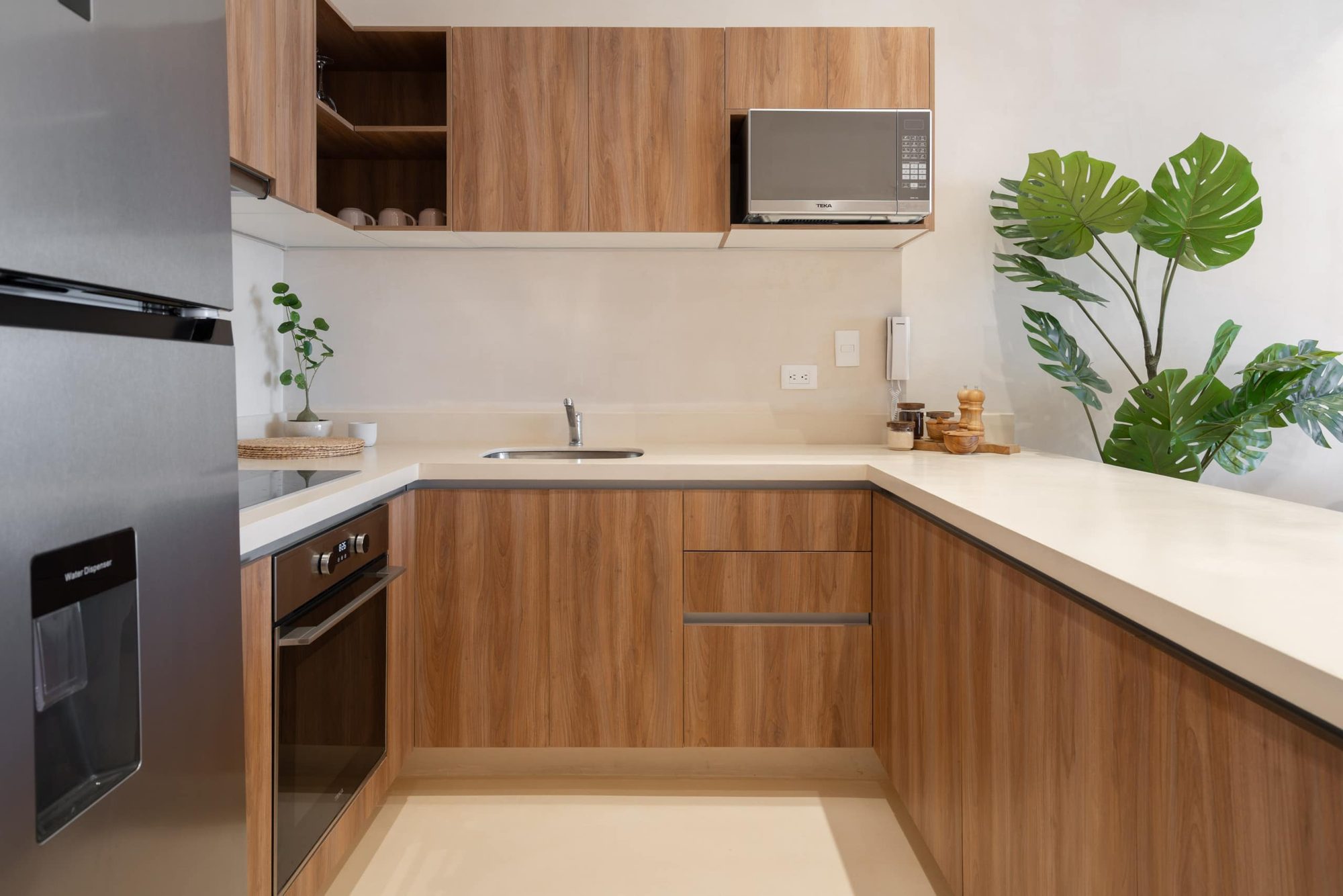 Kitchen with oven, cooktop, microwave and stone counters