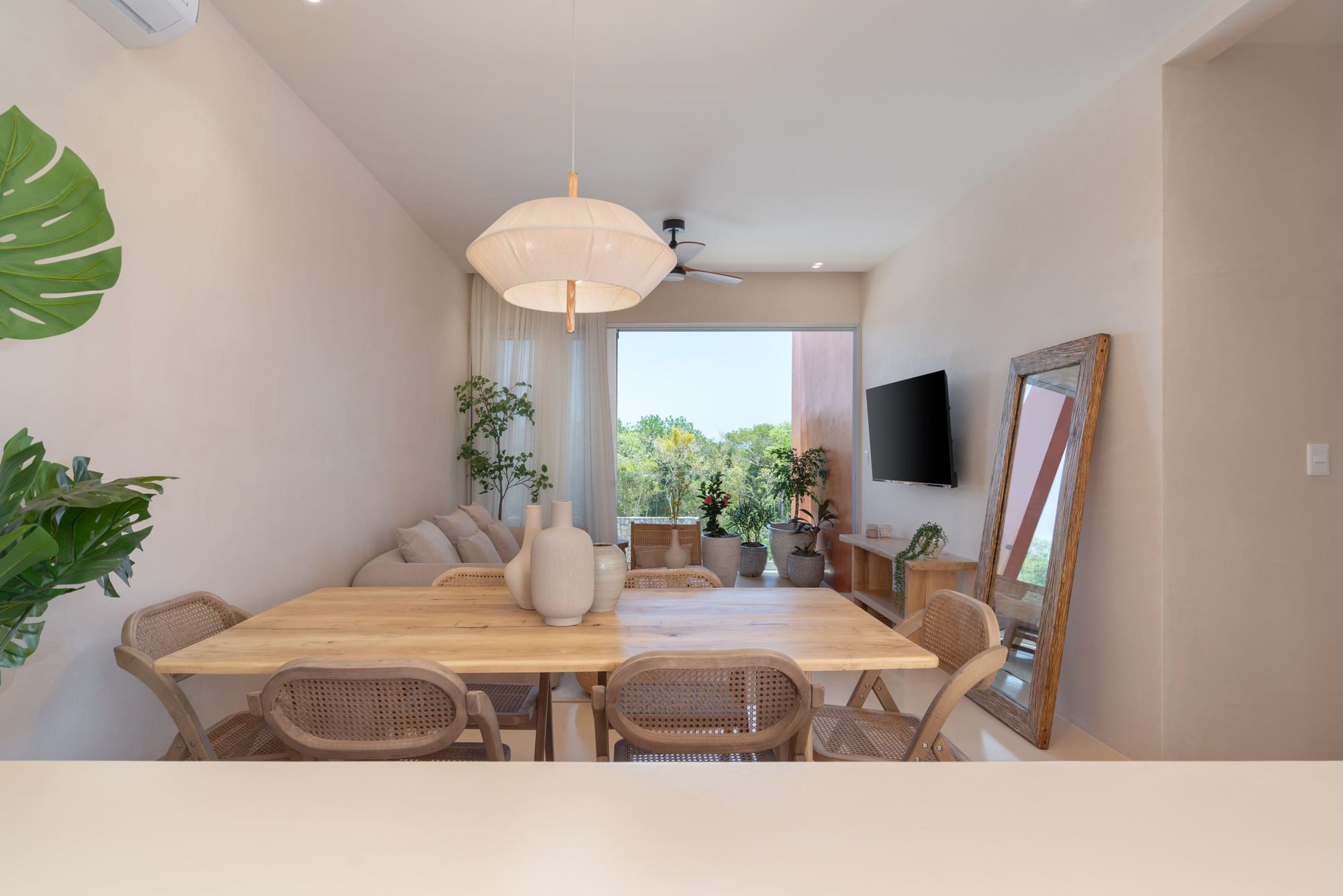 Dining table with a view through to the living room and balcony