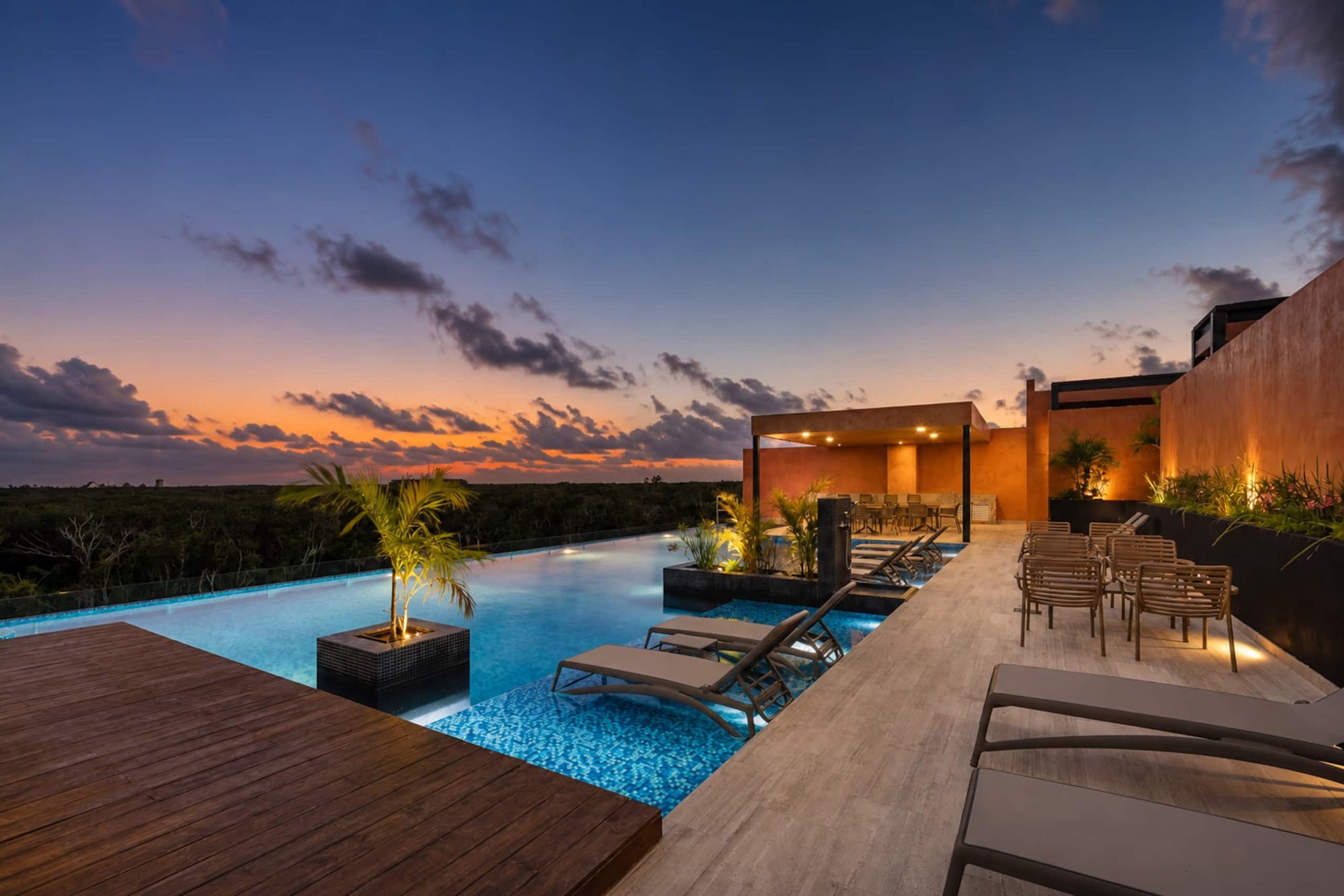 Rooftop pool and deck at sunset