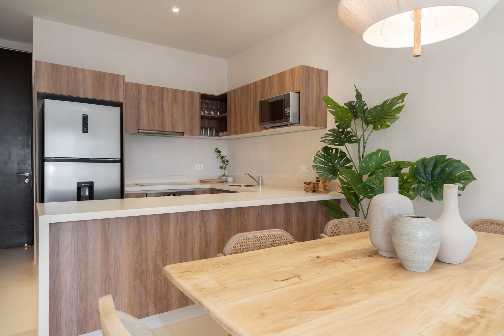 Fully equipped kitchen with wood cabinets and a stainless steel fridge