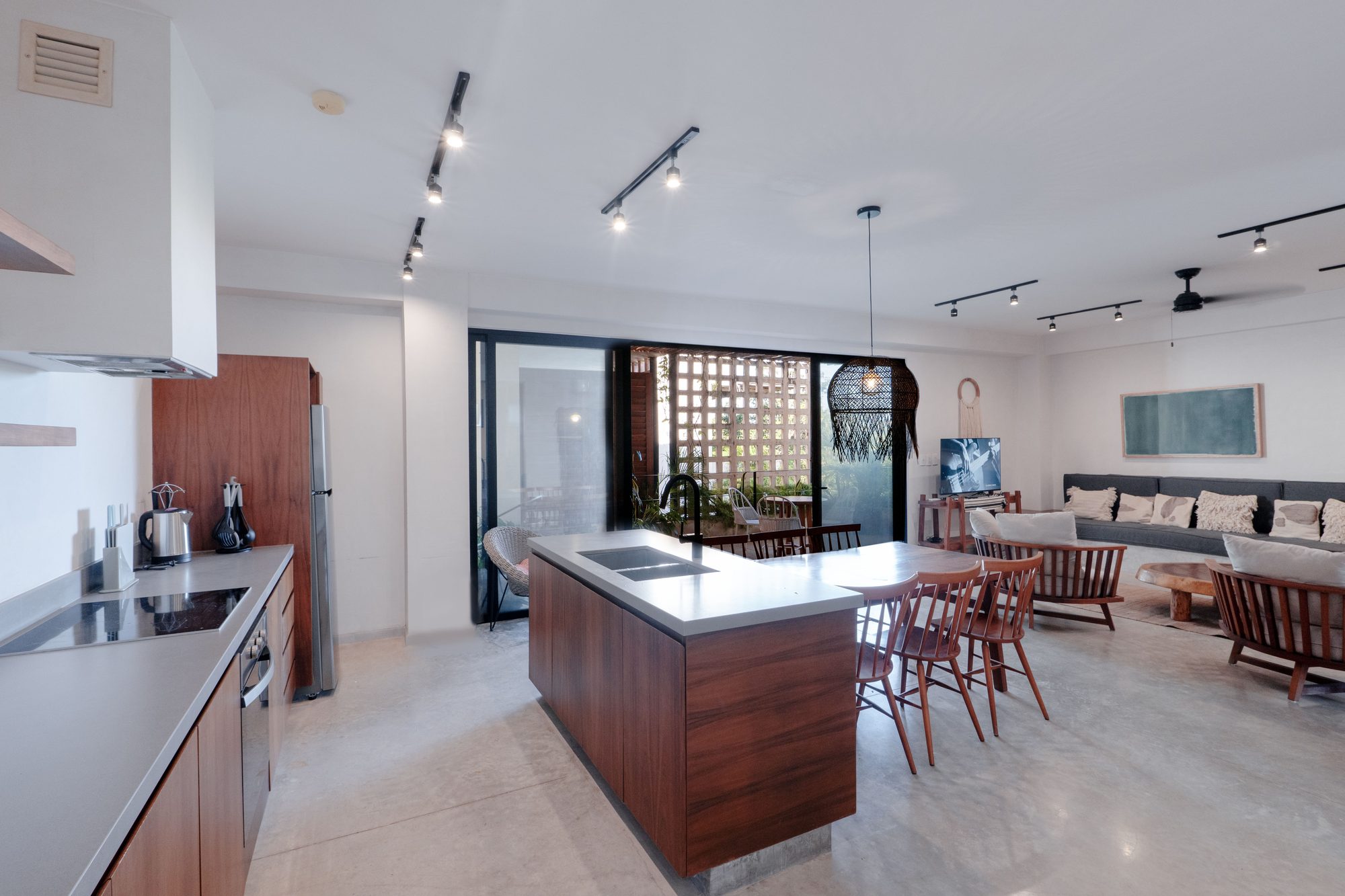 Kitchen island and dining table looking through to the living room and terrace doors